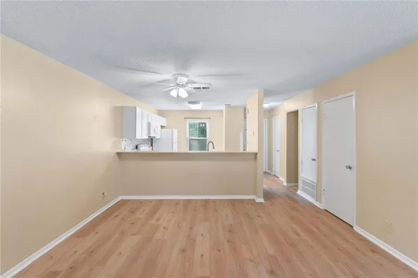 a view of a dining room with furniture a chandelier and wooden floor