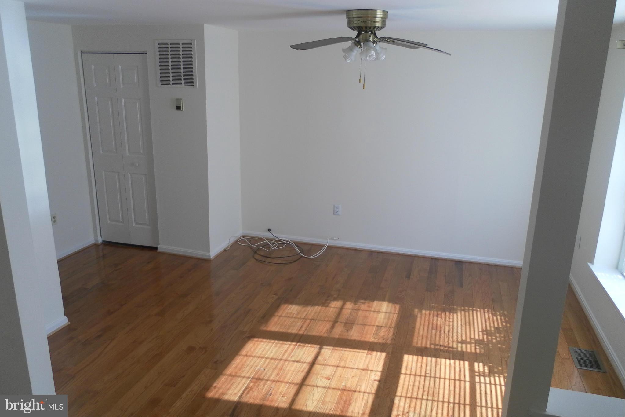 108 East Glebe Road Alexandria, VA 22305 - Photo 3 of 14 a view of empty room with wooden floor and fan