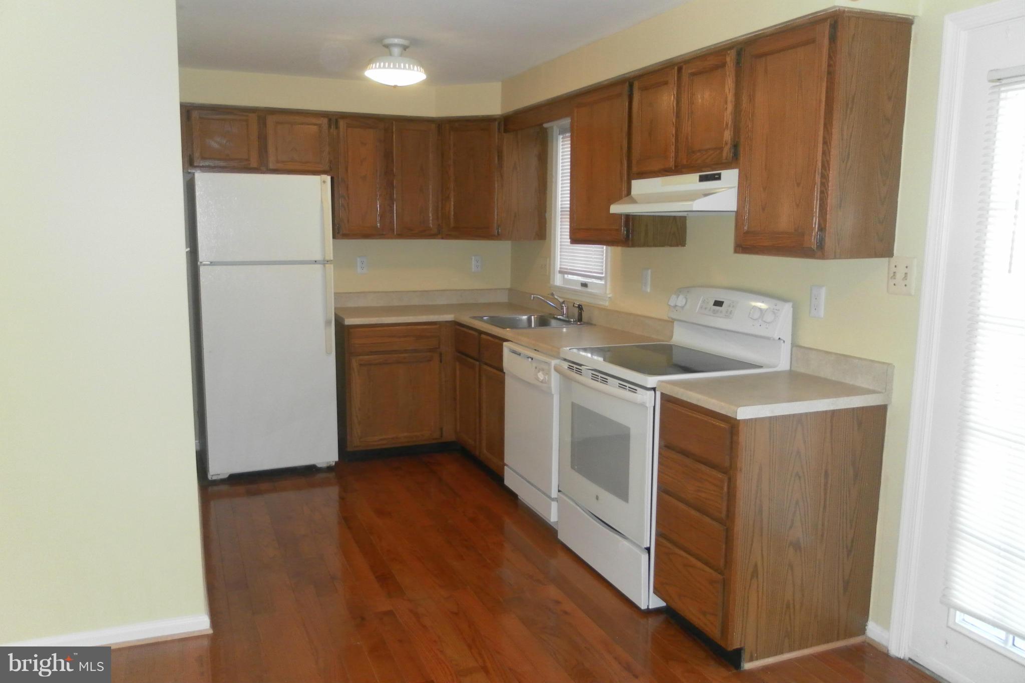 108 East Glebe Road Alexandria, VA 22305 - Photo 5 of 14 a kitchen with a sink a refrigerator a microwave and cabinets