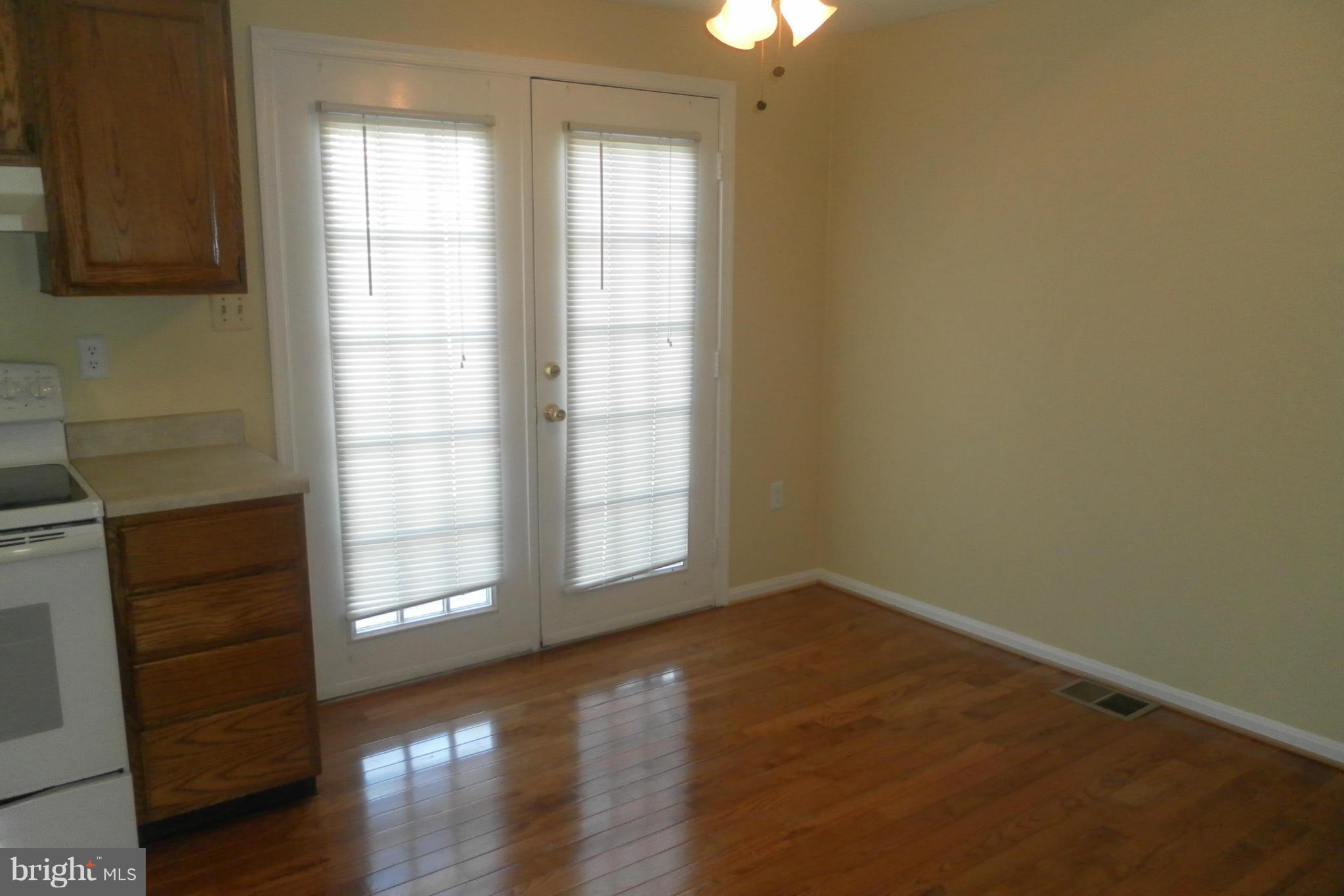 108 East Glebe Road Alexandria, VA 22305 - Photo 7 of 14 an empty room with wooden floor and windows