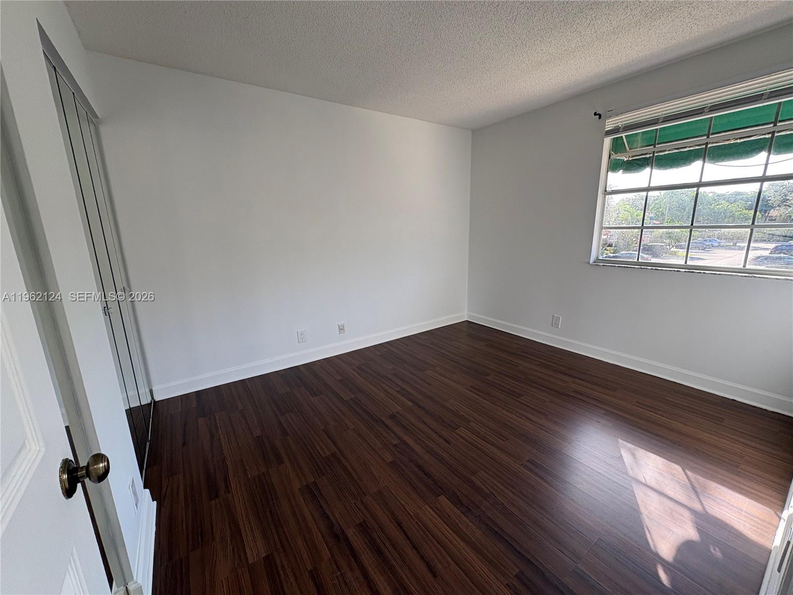 Boca del Mar Boca Raton, FL 33433 - Photo 29 of 41 an empty room with wooden floor and windows