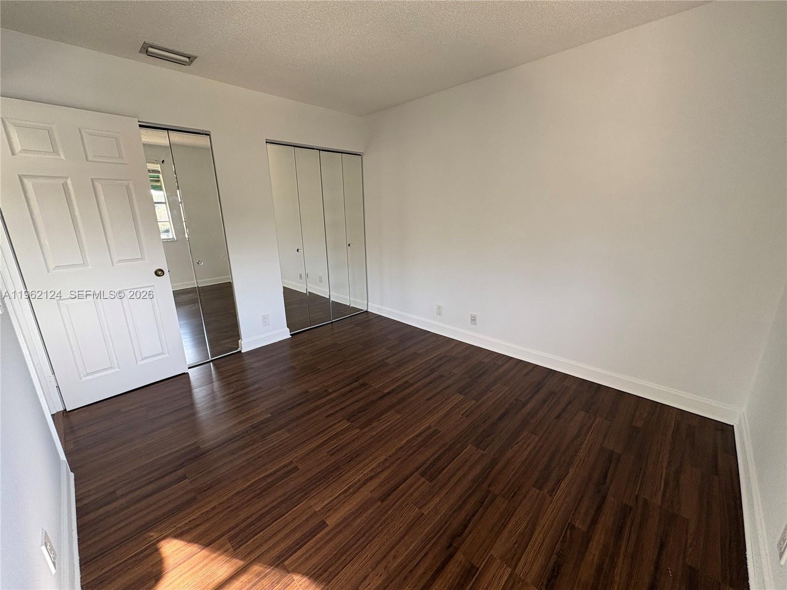 Boca del Mar Boca Raton, FL 33433 - Photo 31 of 41 a view of empty room with wooden floor and fan