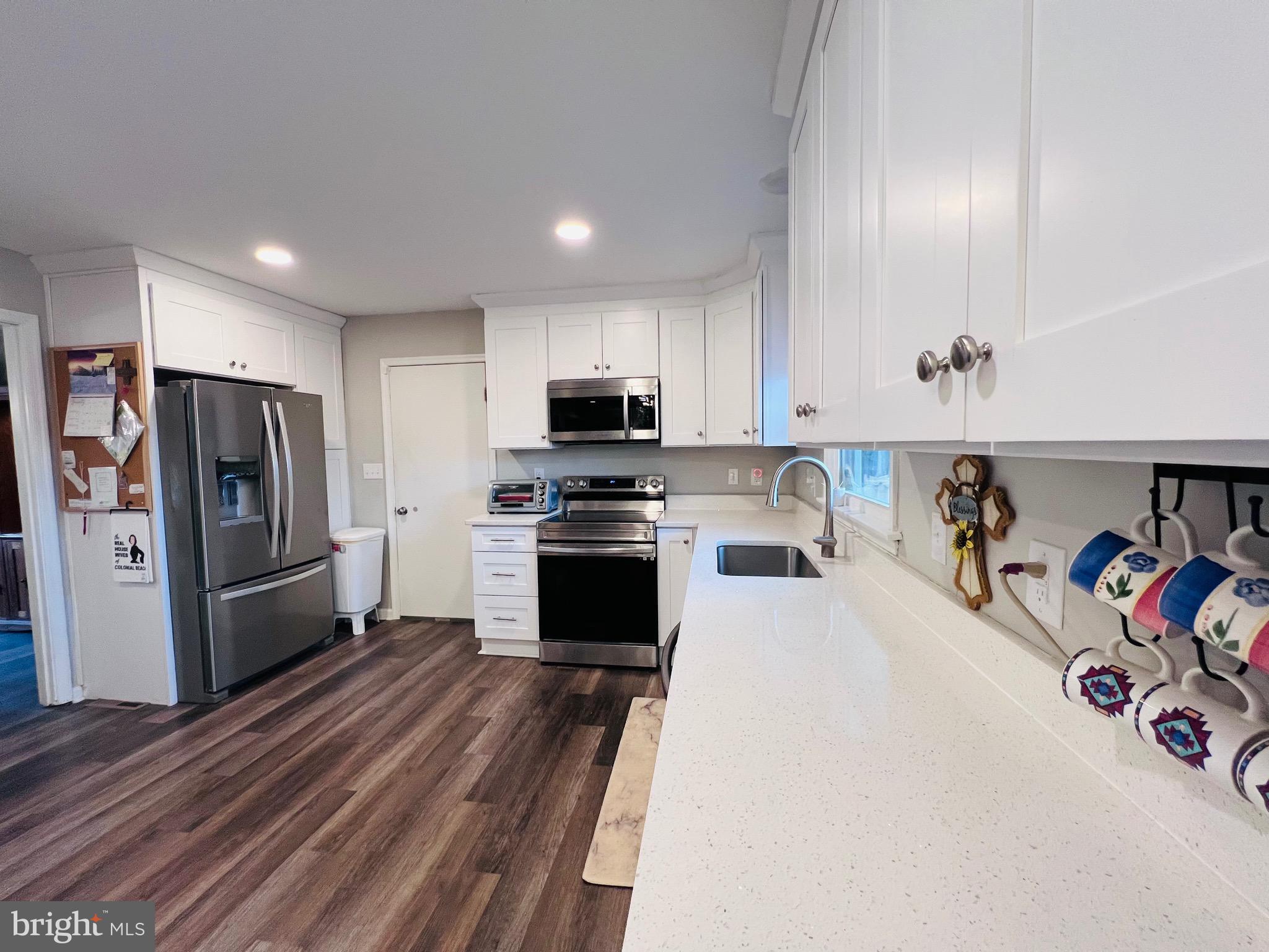 436 Thompson Circle Colonial Beach, VA 22443 - Photo 13 of 40 a kitchen with stainless steel appliances a refrigerator a sink a stove and cabinets