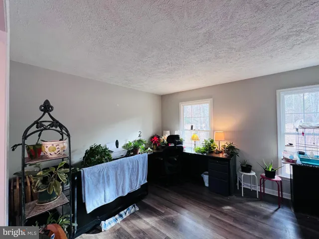 a bedroom with furniture and wooden floor