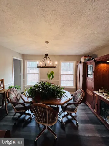 a living room with furniture a window and a flat screen tv