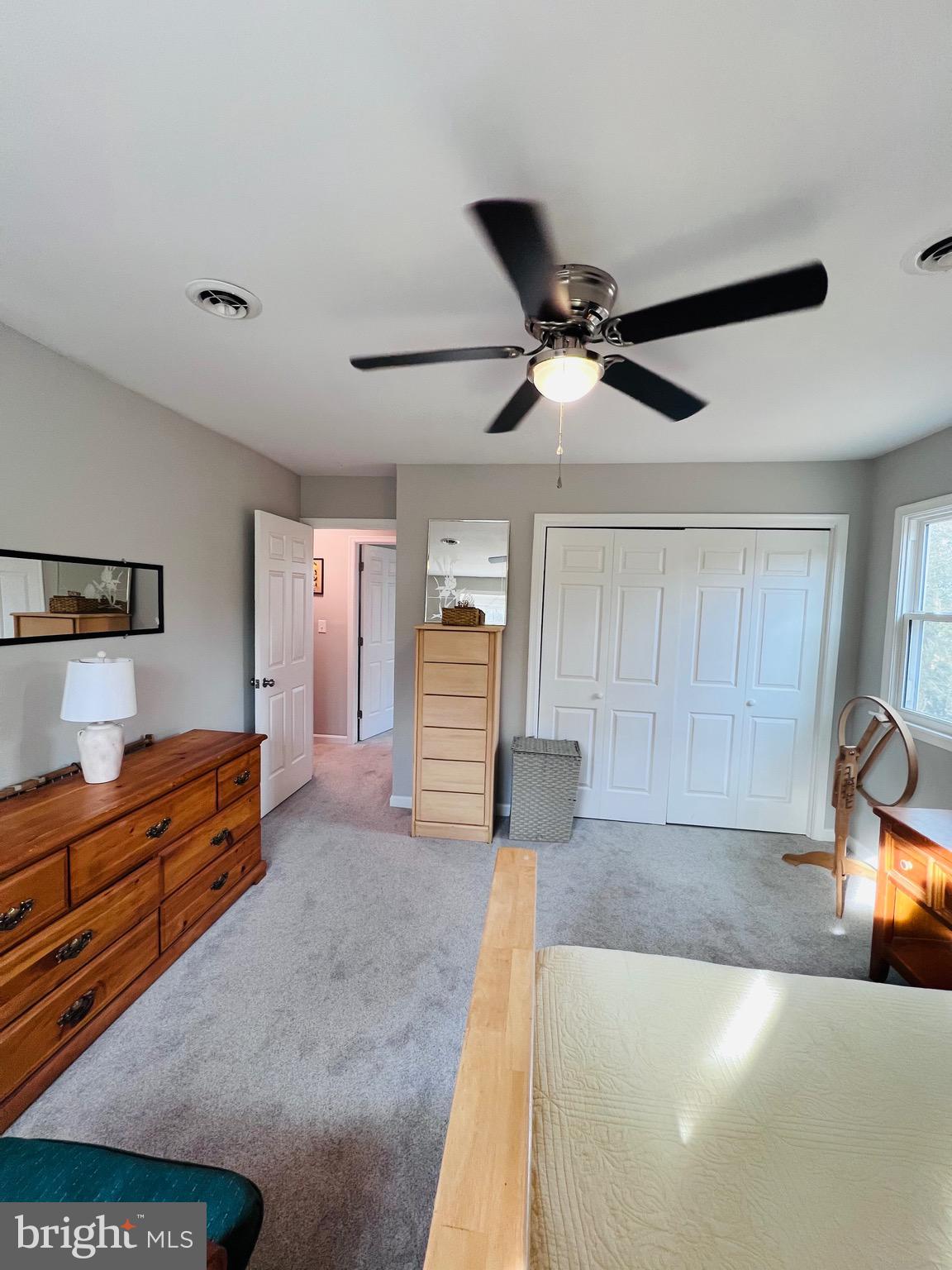 436 Thompson Circle Colonial Beach, VA 22443 - Photo 35 of 40 a large bedroom with a bed and a chandelier