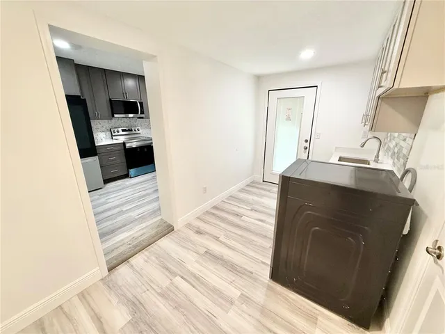 a kitchen with granite countertop a sink and a stove top oven