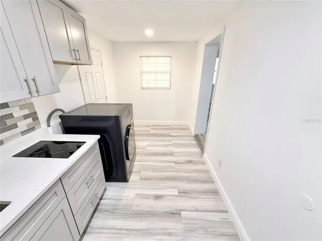 a kitchen with a sink a stove and cabinets