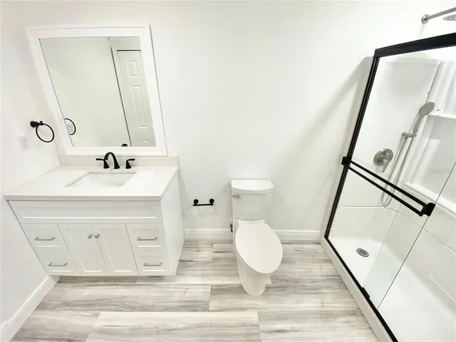 a bathroom with a sink mirror vanity and toilet