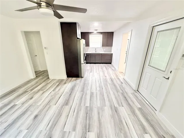 a view of a kitchen from a hallway