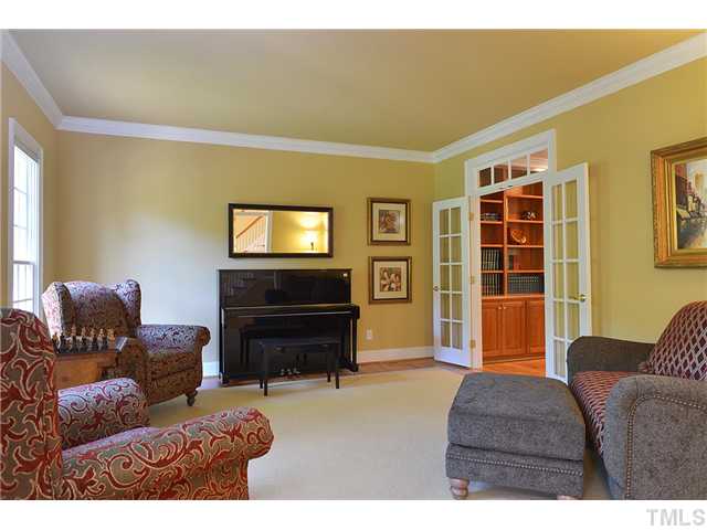 11024 Brass Kettle Road Raleigh, NC 27614 - Photo 4 of 25 a living room with furniture a flat screen tv and a dresser