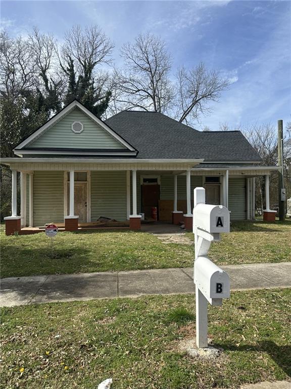 a front view of a house with a yard and porch