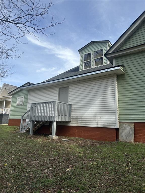 303 Grady Avenue Northeast Rome, GA 30161 - Photo 15 of 17 a view of a house with a yard and deck