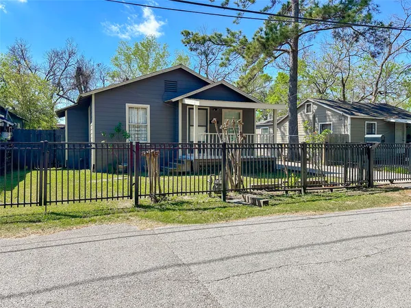 a view of a house with a yard and a garden