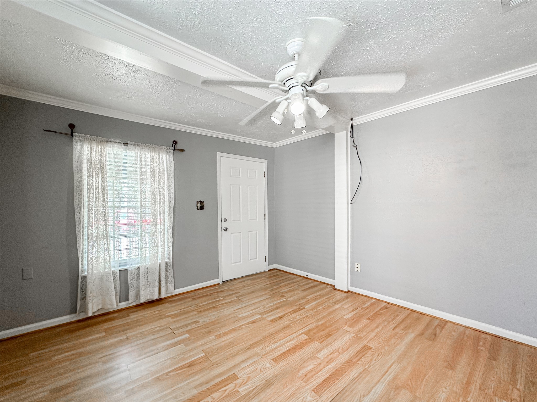132 Grothe Lane Houston, TX 77022 - Photo 11 of 36 a view of an empty room with wooden floor and a window