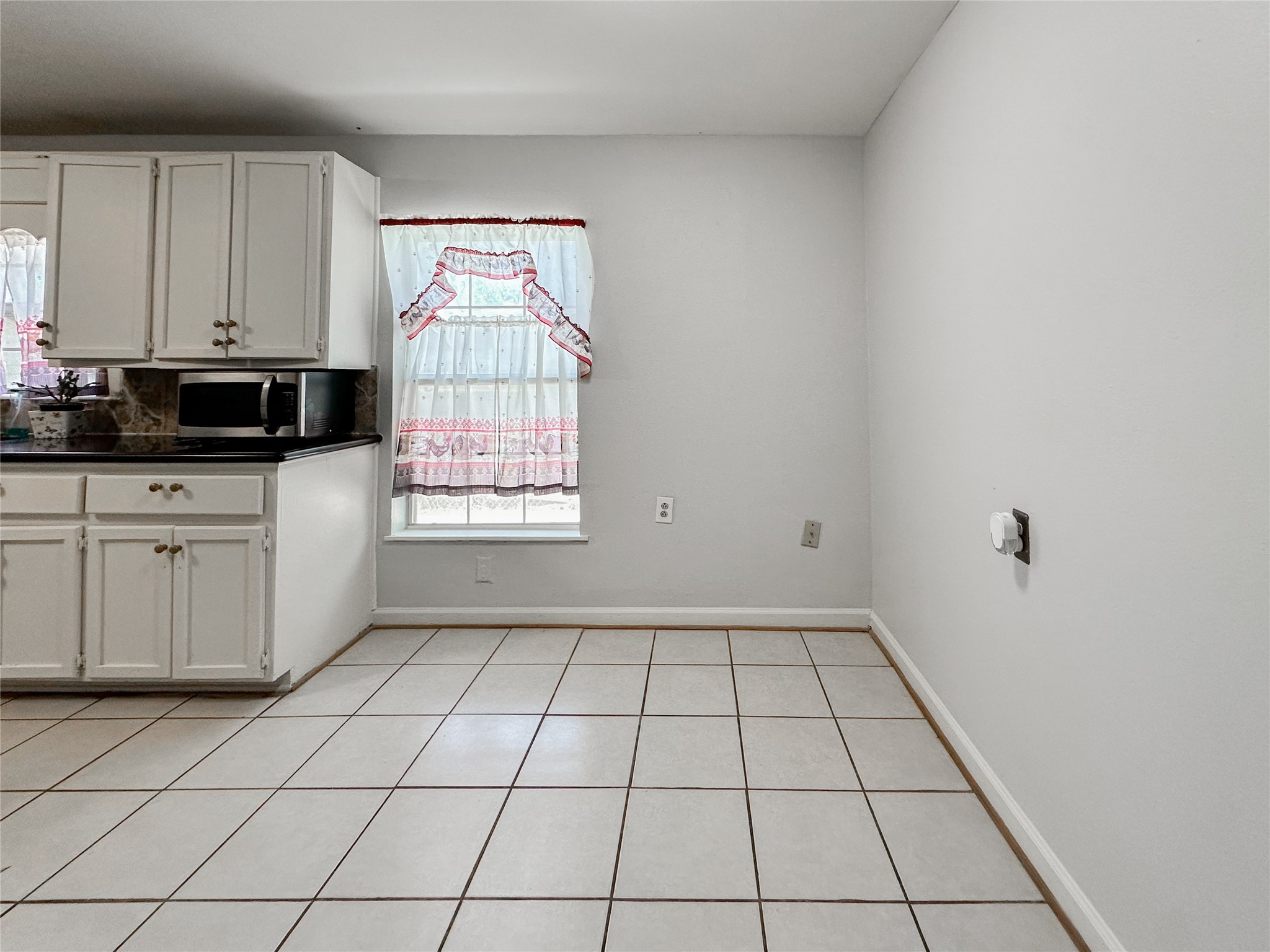 132 Grothe Lane Houston, TX 77022 - Photo 16 of 36 a view of a kitchen with white cabinets appliances and a window