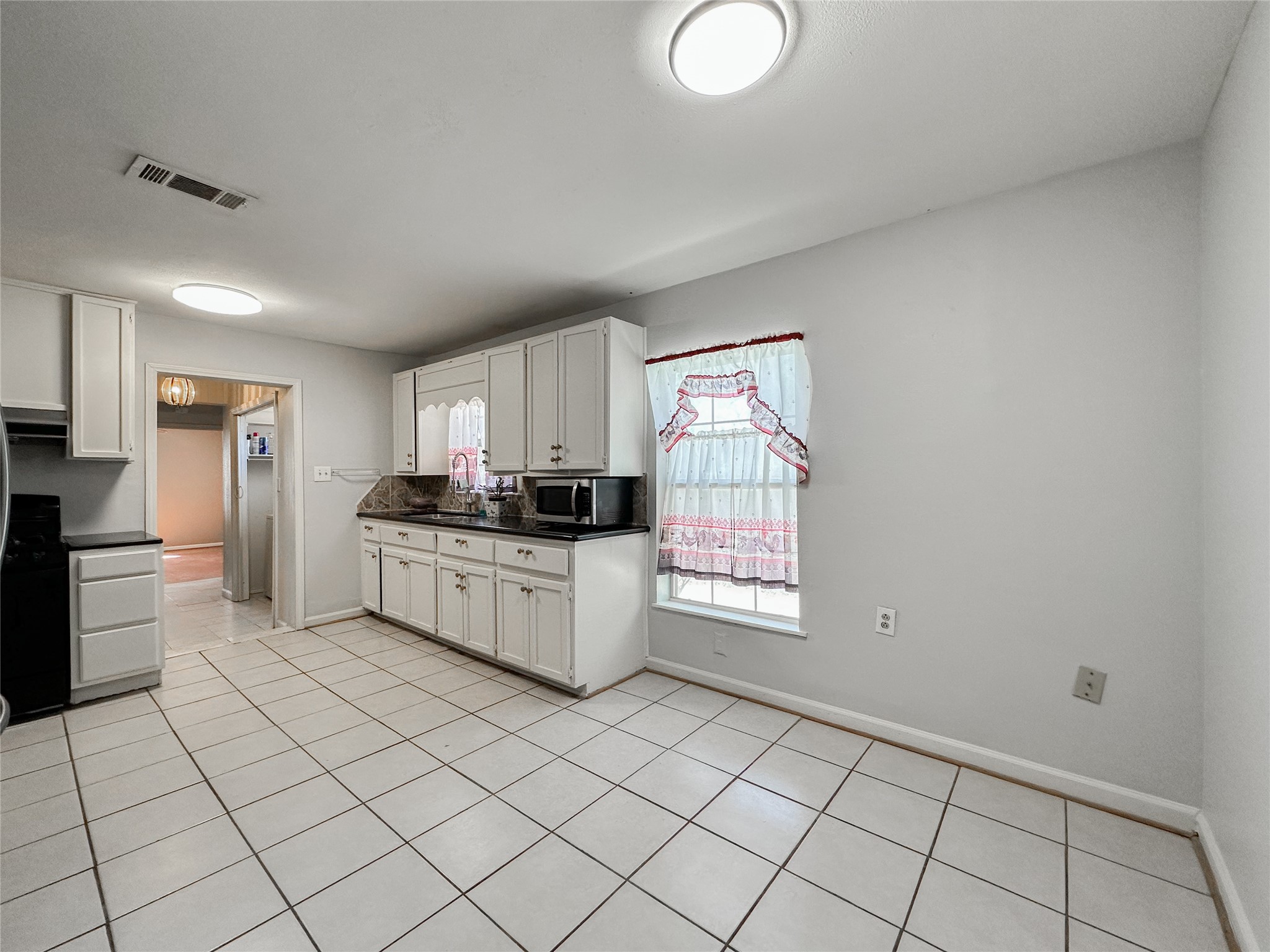 132 Grothe Lane Houston, TX 77022 - Photo 17 of 36 a kitchen with stainless steel appliances a white cabinet and a granite counter tops