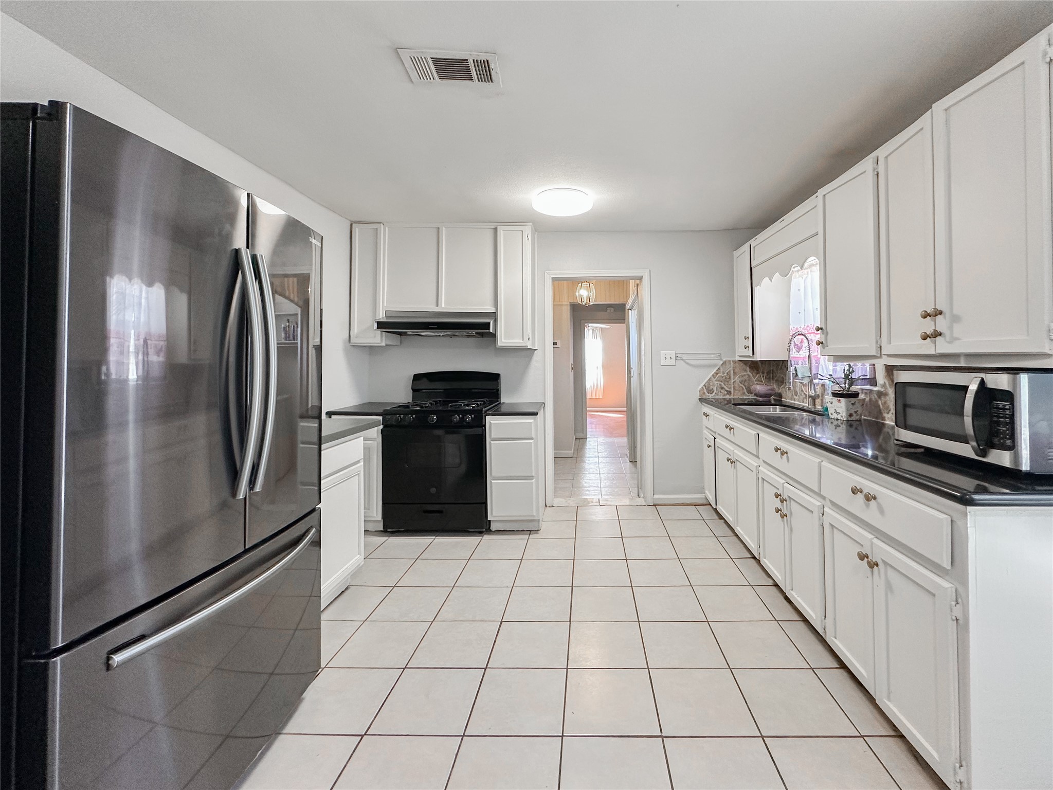 132 Grothe Lane Houston, TX 77022 - Photo 19 of 36 a kitchen with stainless steel appliances granite countertop a refrigerator sink and cabinets