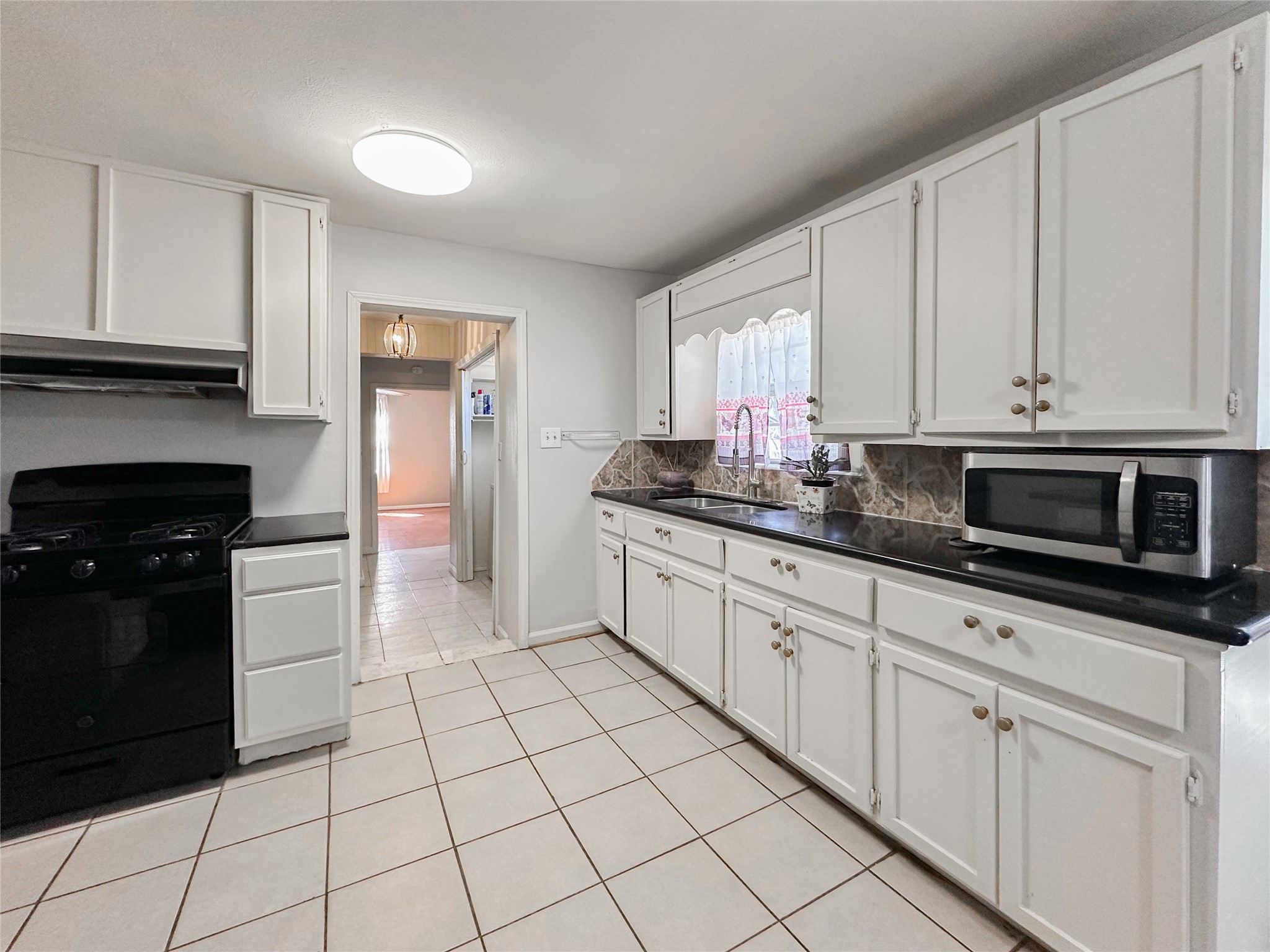 132 Grothe Lane Houston, TX 77022 - Photo 21 of 36 a kitchen with stainless steel appliances granite countertop a sink and a stove