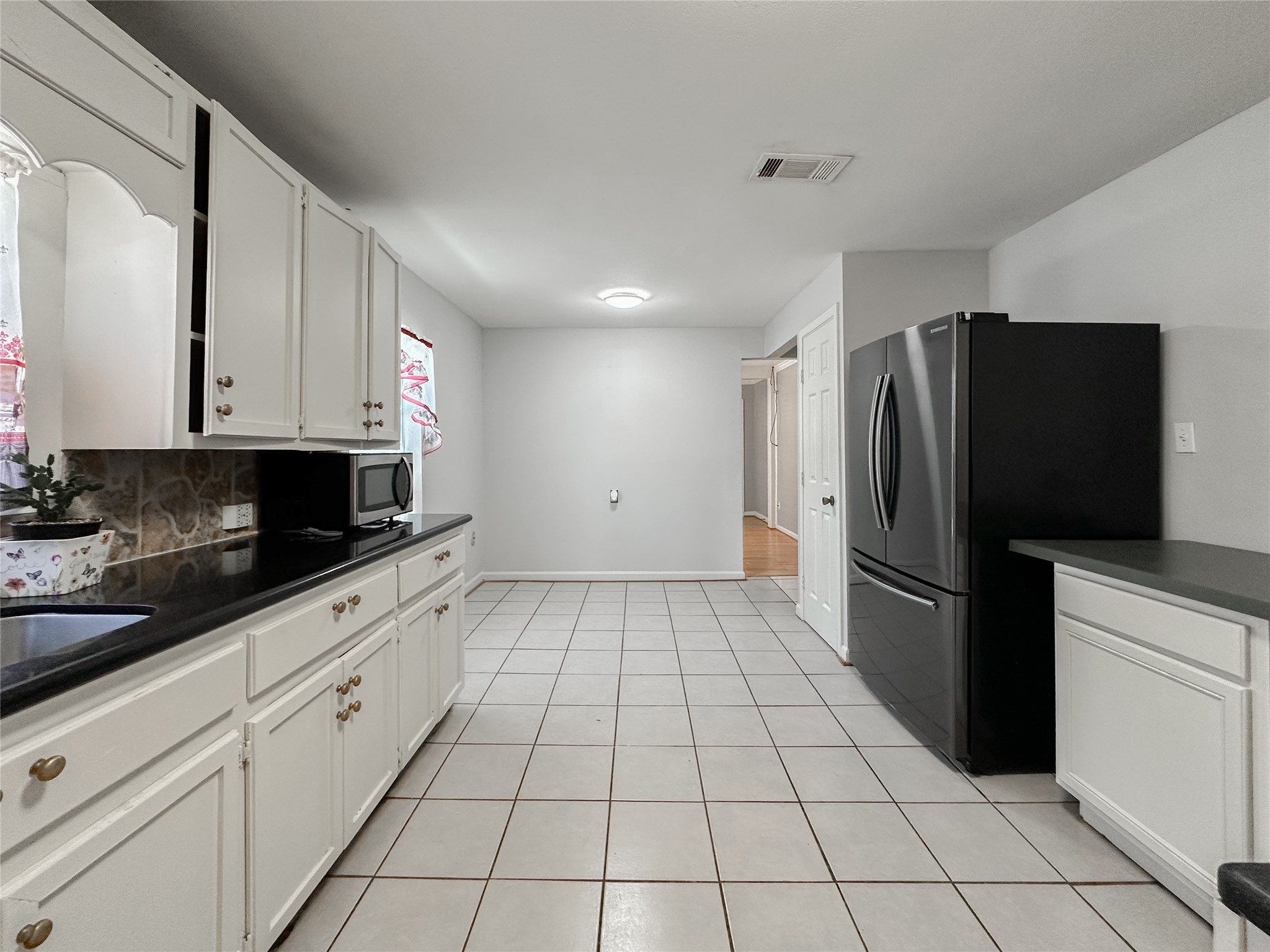 132 Grothe Lane Houston, TX 77022 - Photo 22 of 36 a kitchen with a refrigerator a stove and cabinets