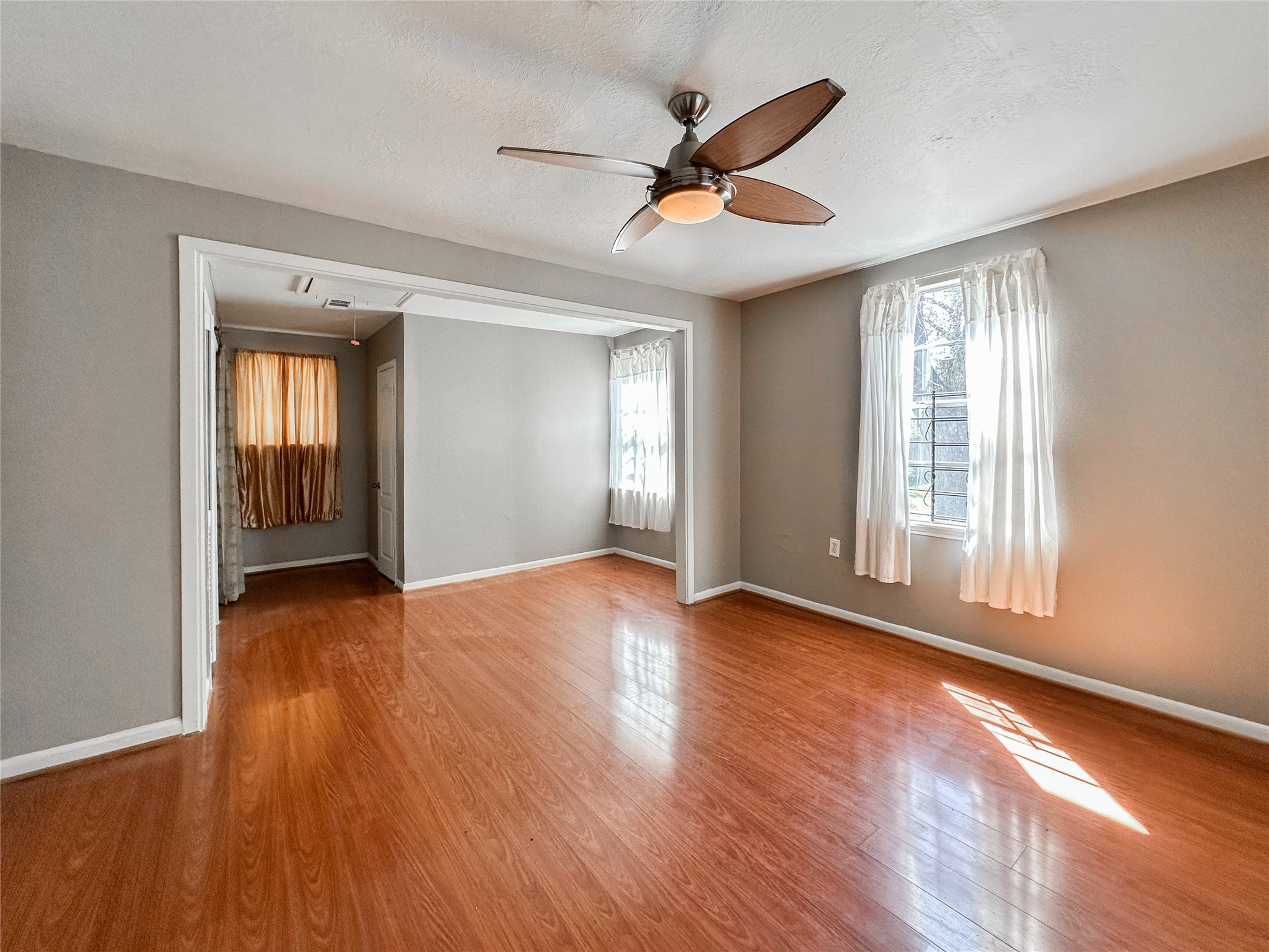 132 Grothe Lane Houston, TX 77022 - Photo 28 of 36 a view of empty room with wooden floor and fan