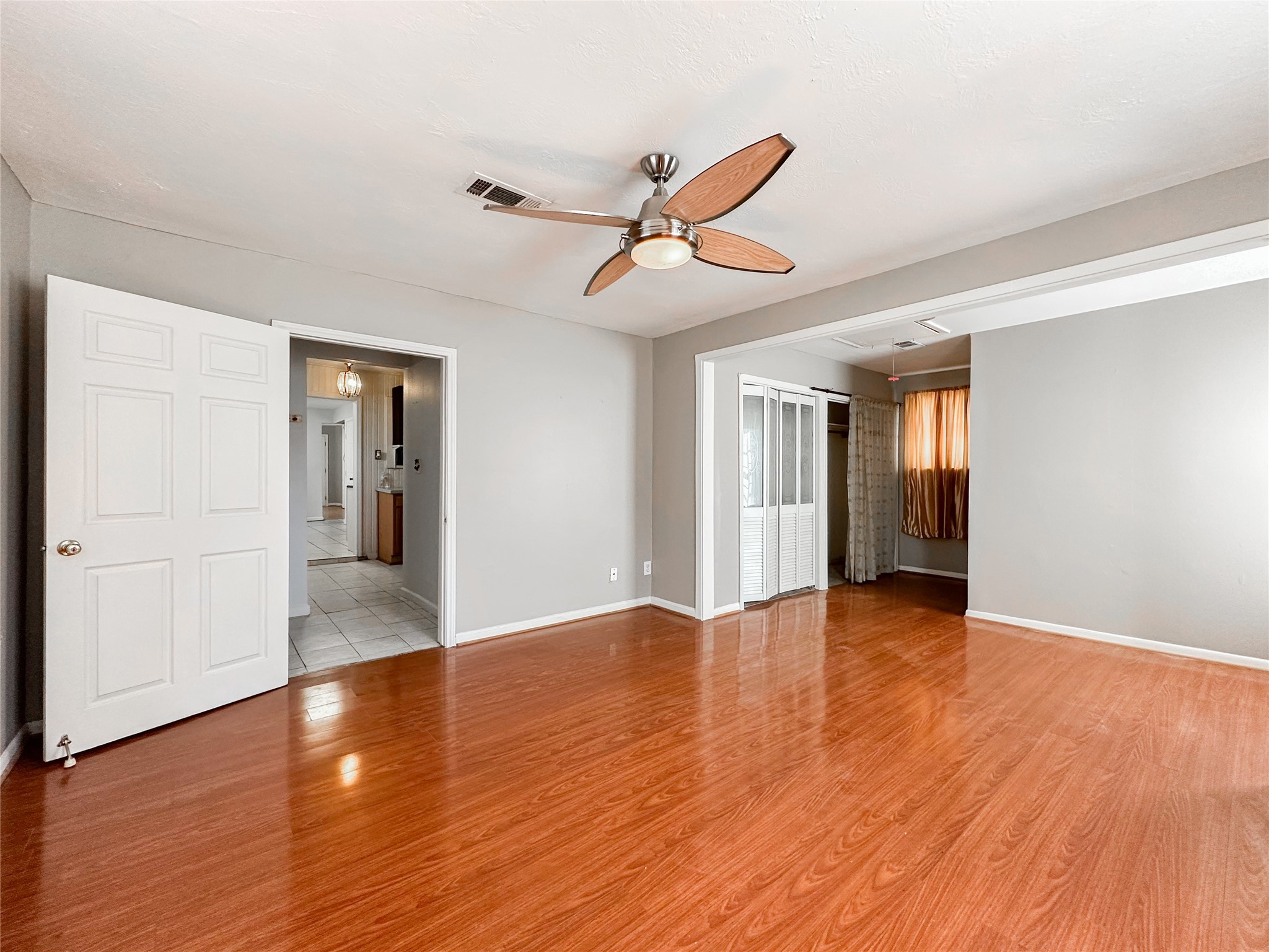 132 Grothe Lane Houston, TX 77022 - Photo 29 of 36 a view of an empty room with wooden floor and a window
