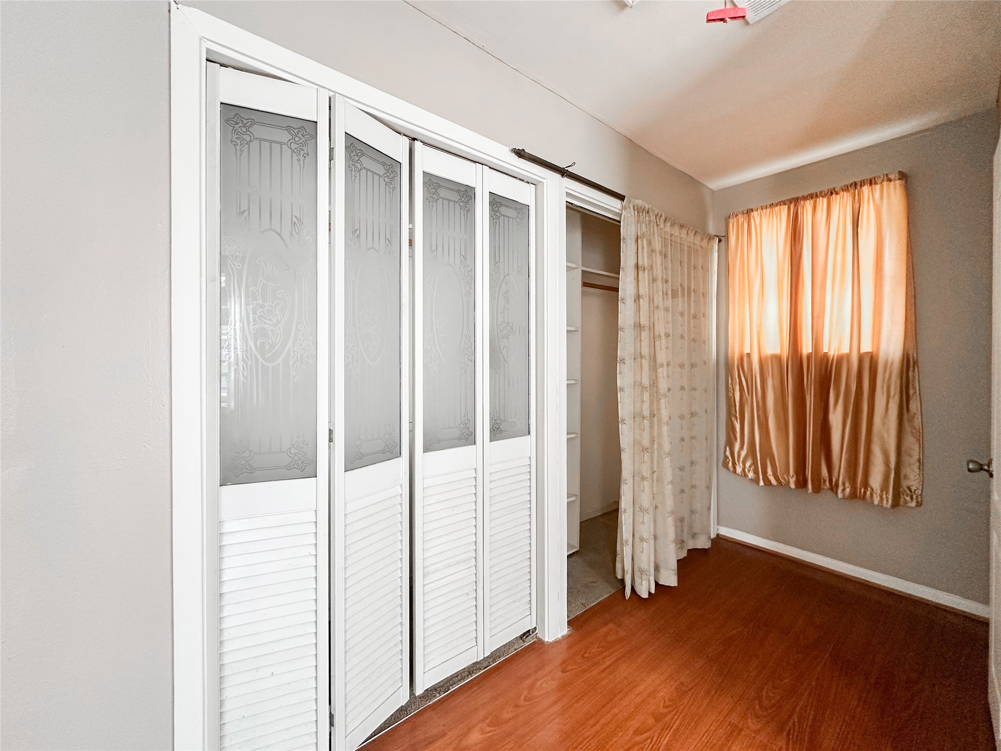 132 Grothe Lane Houston, TX 77022 - Photo 30 of 36 a view of an empty room with wooden floor and a window