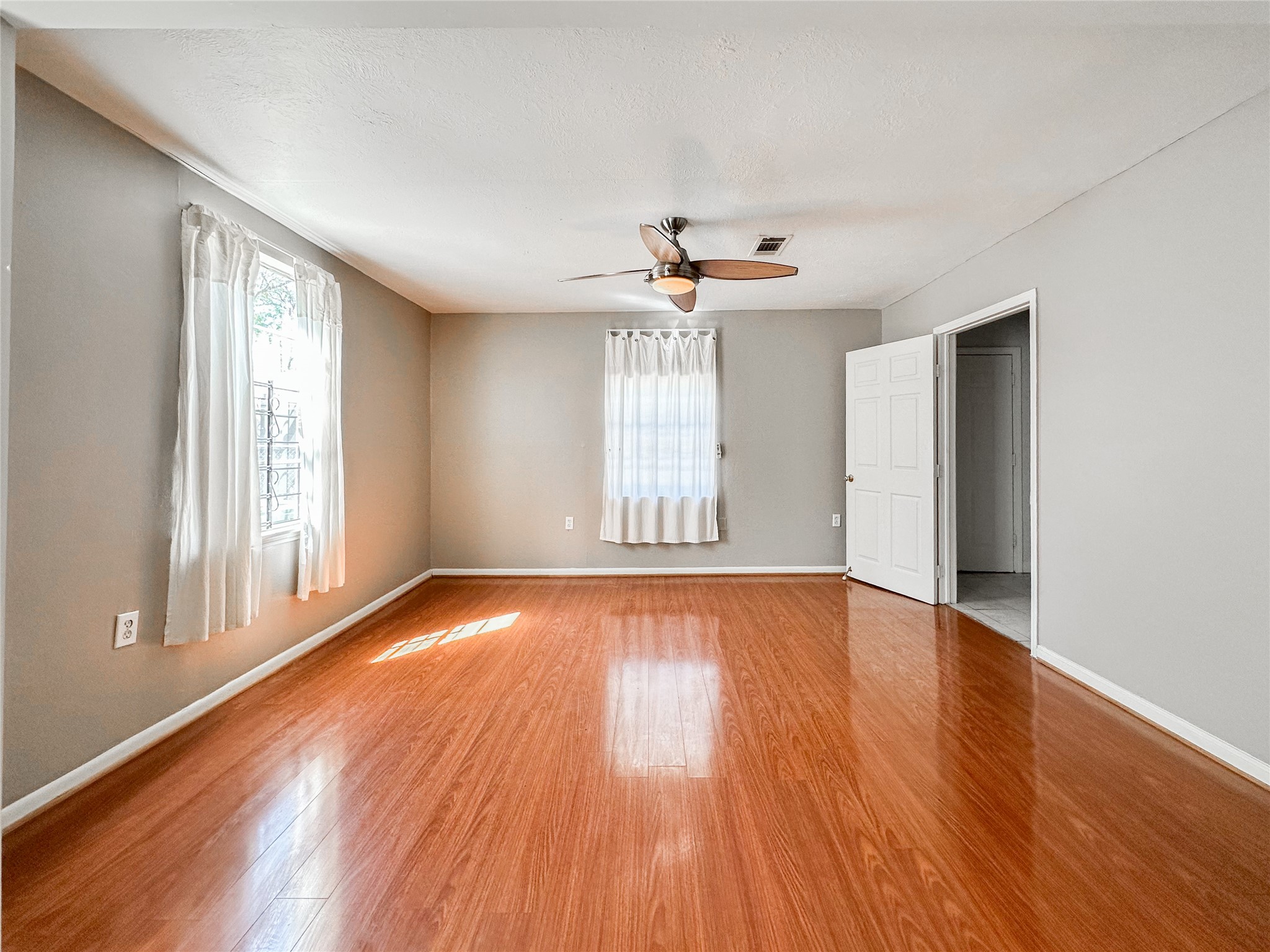 132 Grothe Lane Houston, TX 77022 - Photo 31 of 36 a view of an empty room with wooden floor and a window