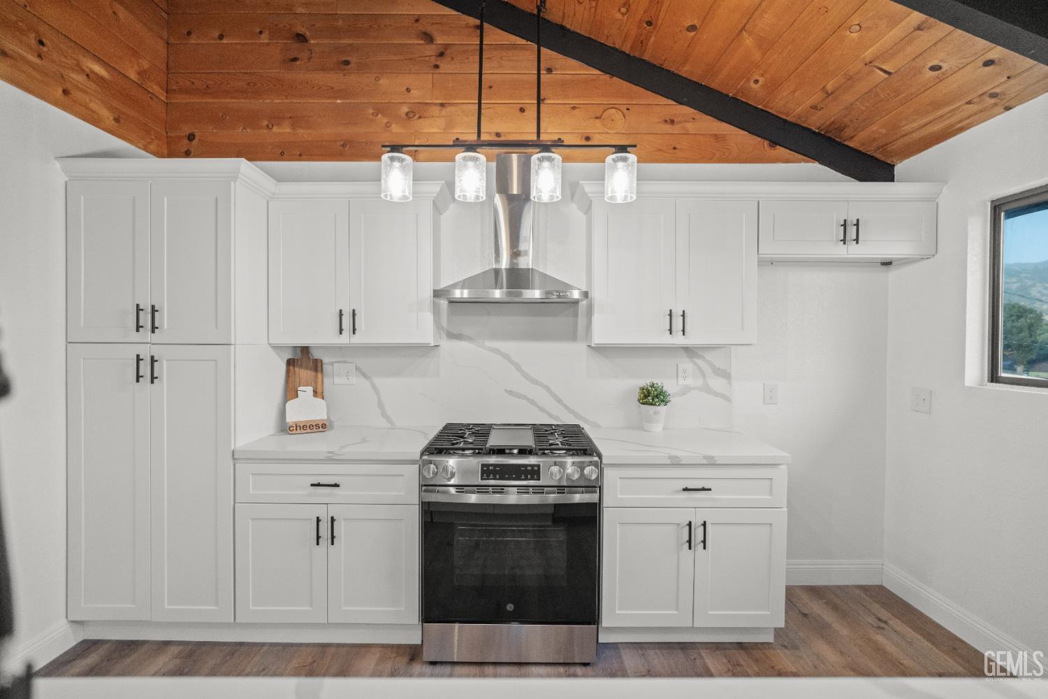 Undisclosed Address Tehachapi, CA 93561 - Photo 12 of 60 a kitchen with stainless steel appliances a stove and white cabinets