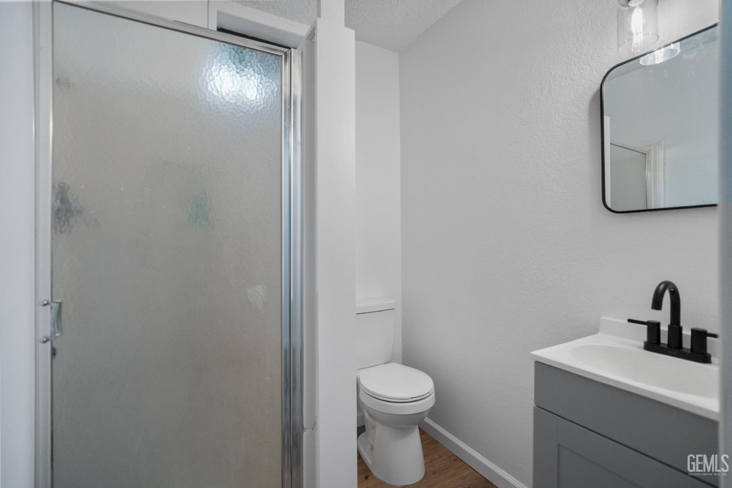 Undisclosed Address Tehachapi, CA 93561 - Photo 43 of 60 a bathroom with a toilet a sink and mirror