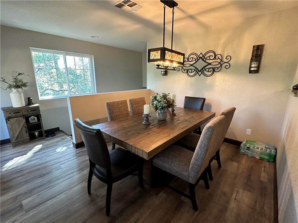 6615 Flag Mine Road Kingman, AZ 86401 - Photo 21 of 72 a view of a dining room with furniture window and wooden floor