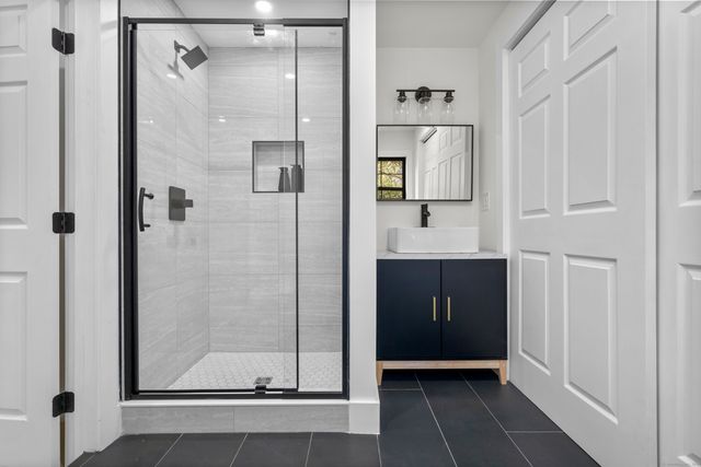 a bathroom with a shower and a mirror