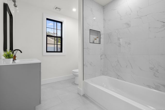 a bathroom with a bathtub sink and toilet