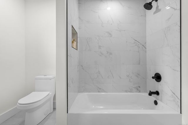 a bathroom with a bathtub and a toilet