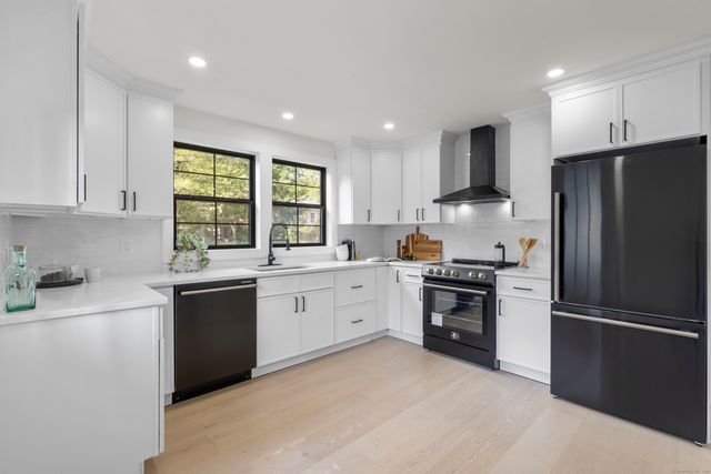 a kitchen with a refrigerator stove and sink
