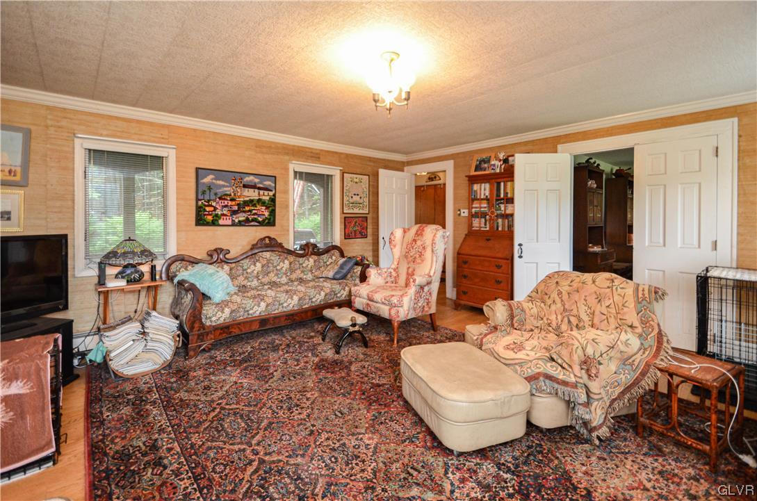 234 Rinker Road Stroudsburg, PA 18360 - Photo 9 of 49 a living room with furniture a flat screen tv and a large window