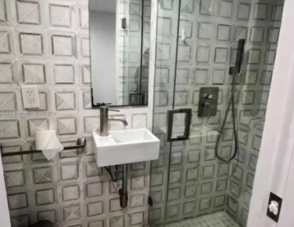 a bathroom with a sink and mirror