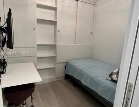 a bedroom with a bed and a chair