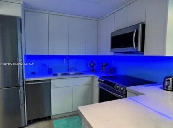 a room with red chairs and flat screen tv