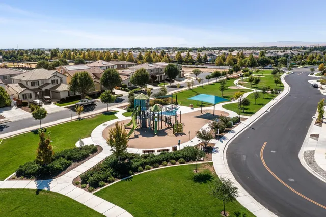 an aerial view of a house with a garden and lake view