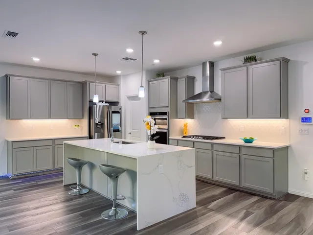 a view of empty room with window and wooden floor