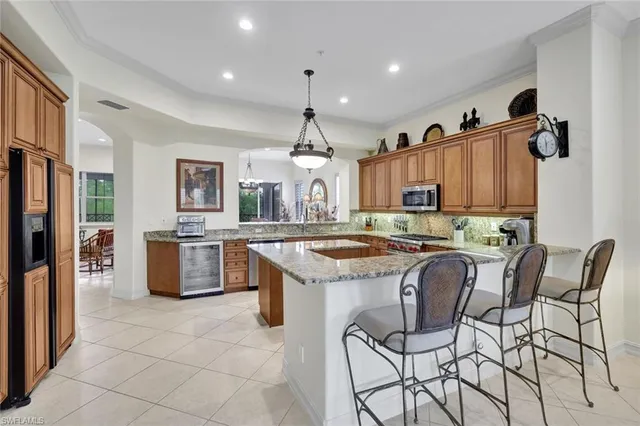 a kitchen with stainless steel appliances granite countertop a stove and a refrigerator