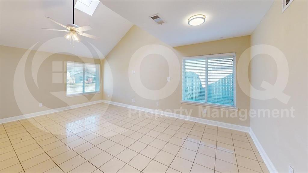 3005 Meandering Way Bedford, TX 76021 - Photo 6 of 24 Spacious room featuring vaulted ceilings, light-toned tile flooring, and multiple windows with blinds