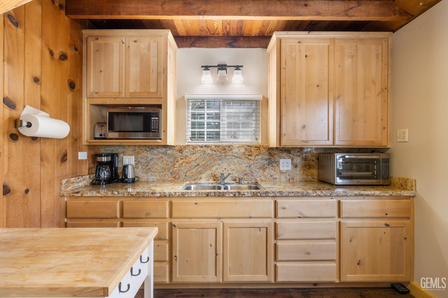 Undisclosed Address Posey, CA 93260 - Photo 22 of 53 a kitchen with granite countertop a sink a stove and cabinets
