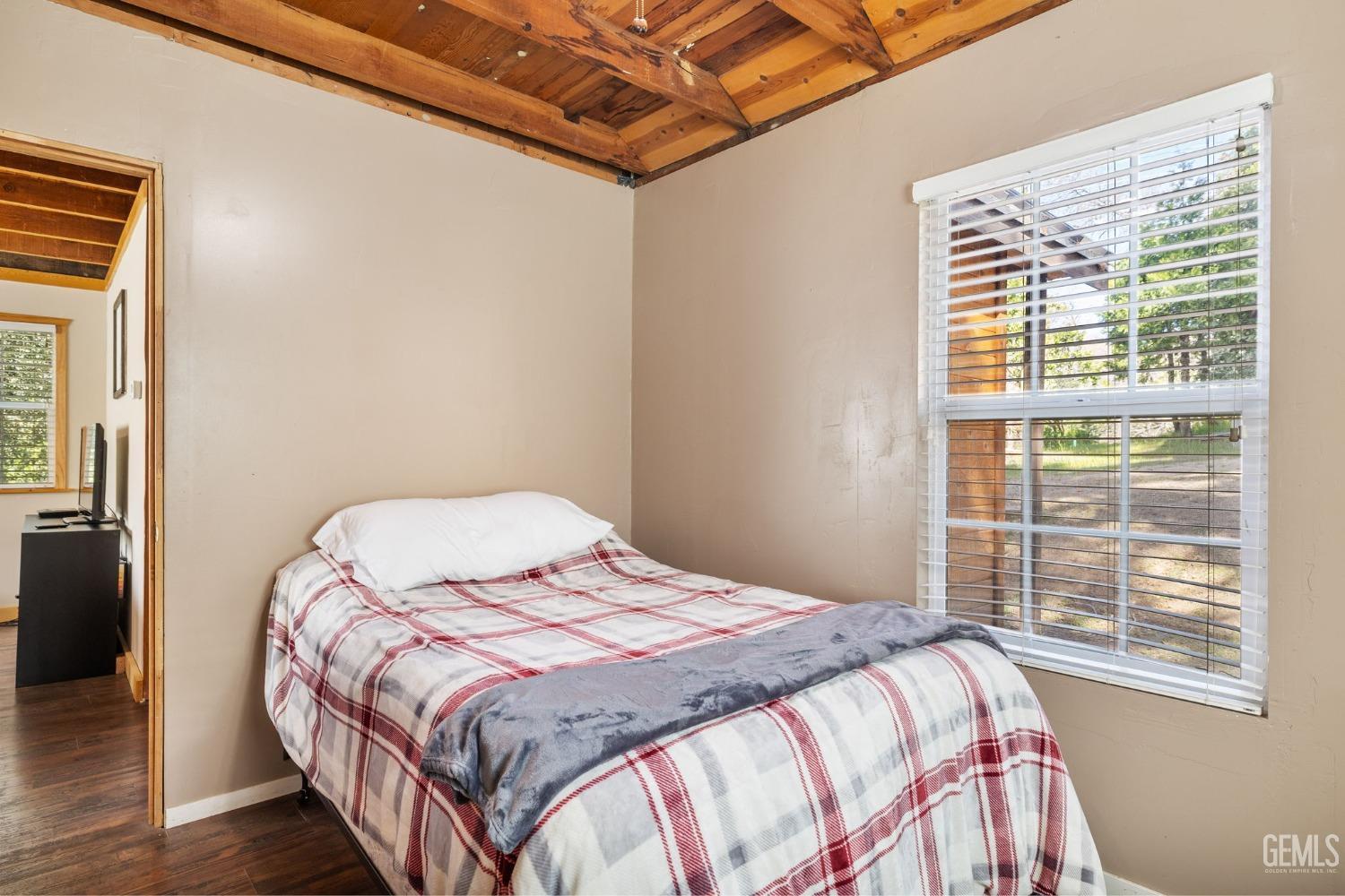 Undisclosed Address Posey, CA 93260 - Photo 24 of 53 a bedroom with a bed and wooden floor