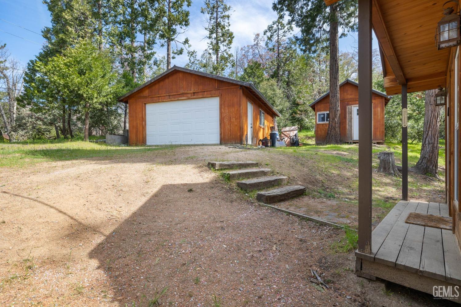 Undisclosed Address Posey, CA 93260 - Photo 48 of 53 a front view of a house with a yard and garage