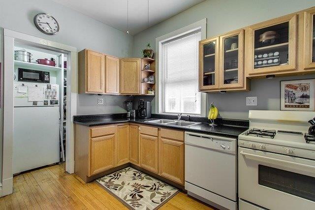 4817 North Winchester Avenue, Unit 2 Chicago, IL 60640 - Photo 2 of 9 a kitchen with stainless steel appliances granite countertop a stove a sink and a refrigerator