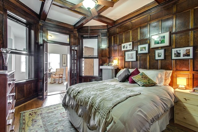 4817 North Winchester Avenue, Unit 2 Chicago, IL 60640 - Photo 4 of 9 a bed sitting in a bedroom next to a window