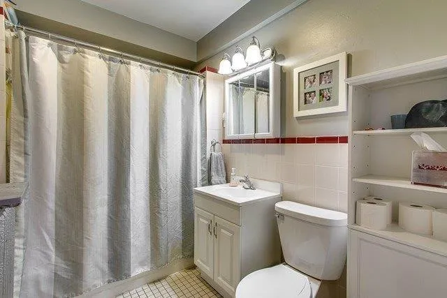 a white toilet sitting next to a bathroom sink