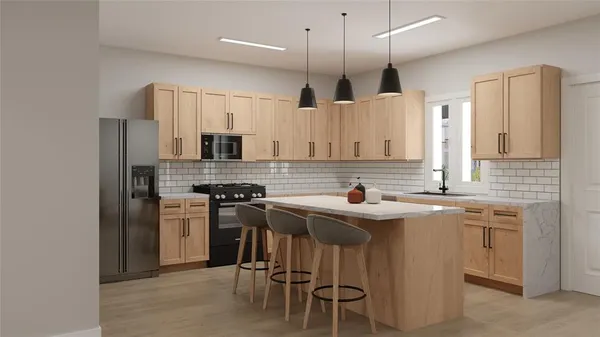 a kitchen with stainless steel appliances granite countertop a sink stove a refrigerator and a microwave